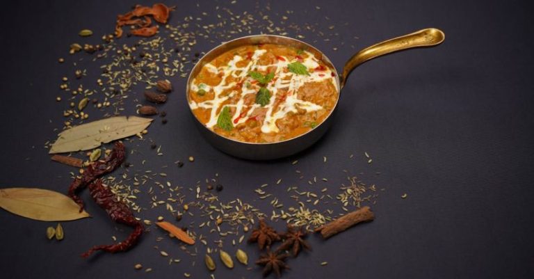 Cooking Methods - A pan filled with food and spices on a black background