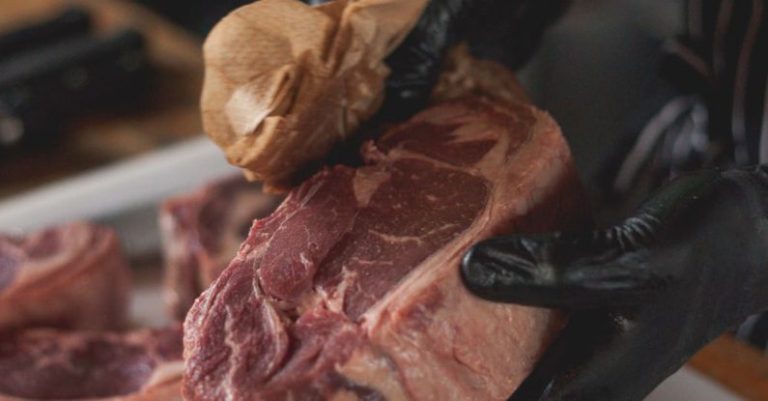 Dry-Aged Steak - A Person Wiping Raw Steak with Paper Towel