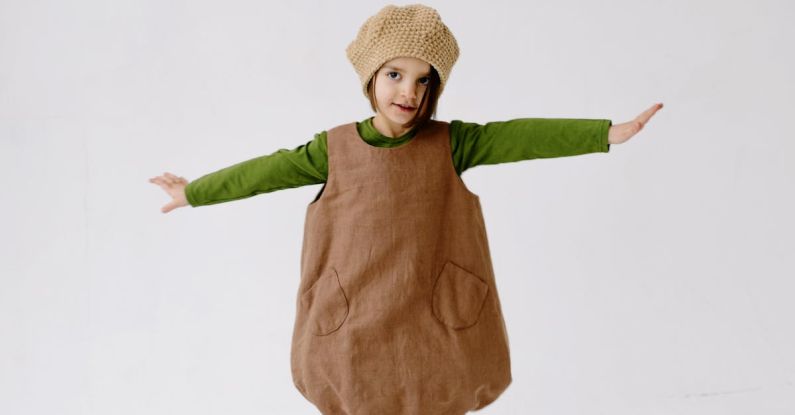 Sides - A Girl in Acorn Costume Posing with Arms Raised on Both Sides