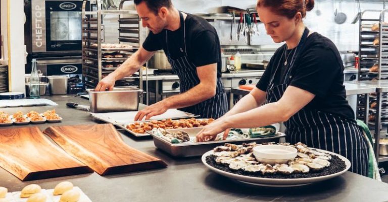 Chefs - Man and Woman Wearing Black and White Striped Aprons Cooking