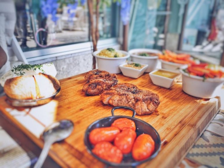 Steakhouses - grilled meat on brown wooden tray