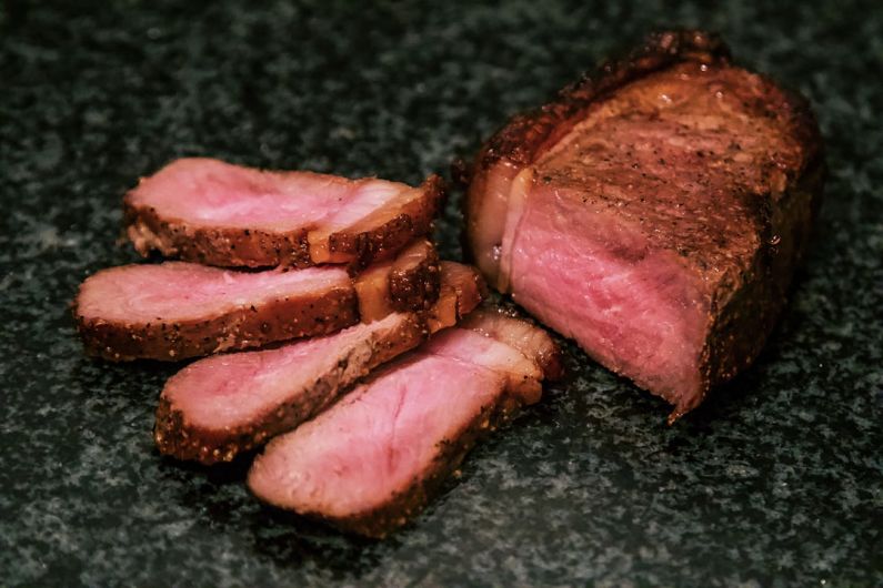 Steakhouse - sliced meat on black surface