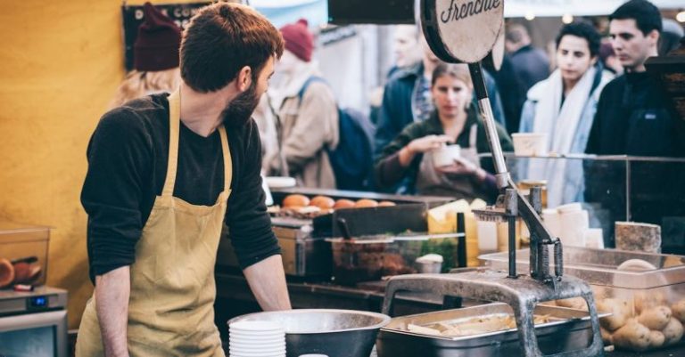 Food Festival - Man Standing in Front of Bowl and Looking Towards Left