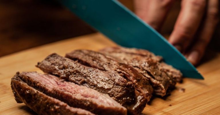 Steak Cuts - Person Slicing Meat on Brown Chopping Board