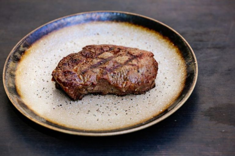 Steakhouses - a piece of meat on a plate